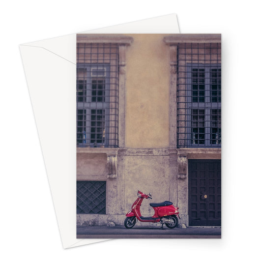 Red scooter parked outside a building in Rome, Italy. Greeting Card