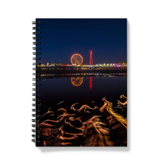 Blackpool Tower and Central Pier at night, with reflection of illuminations in water on the beach  UK. Notebook