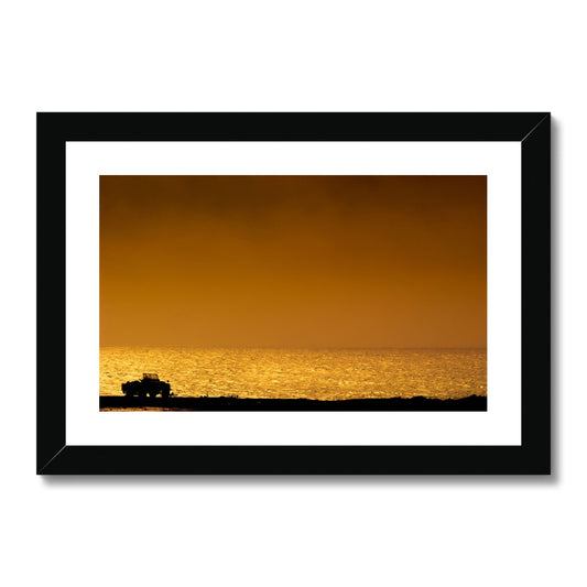 Silhouette of jeep on beach at sunset Framed & Mounted Print