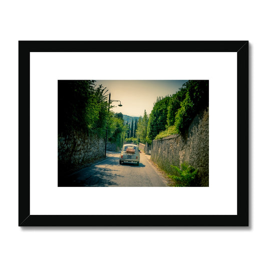 Classic Fiat 500 car driving on a road in Florence, Italy. Framed & Mounted Print