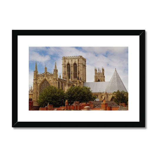 York Minster towering over York's historic rooftops. York. North Yorkshire. UK Framed & Mounted Print